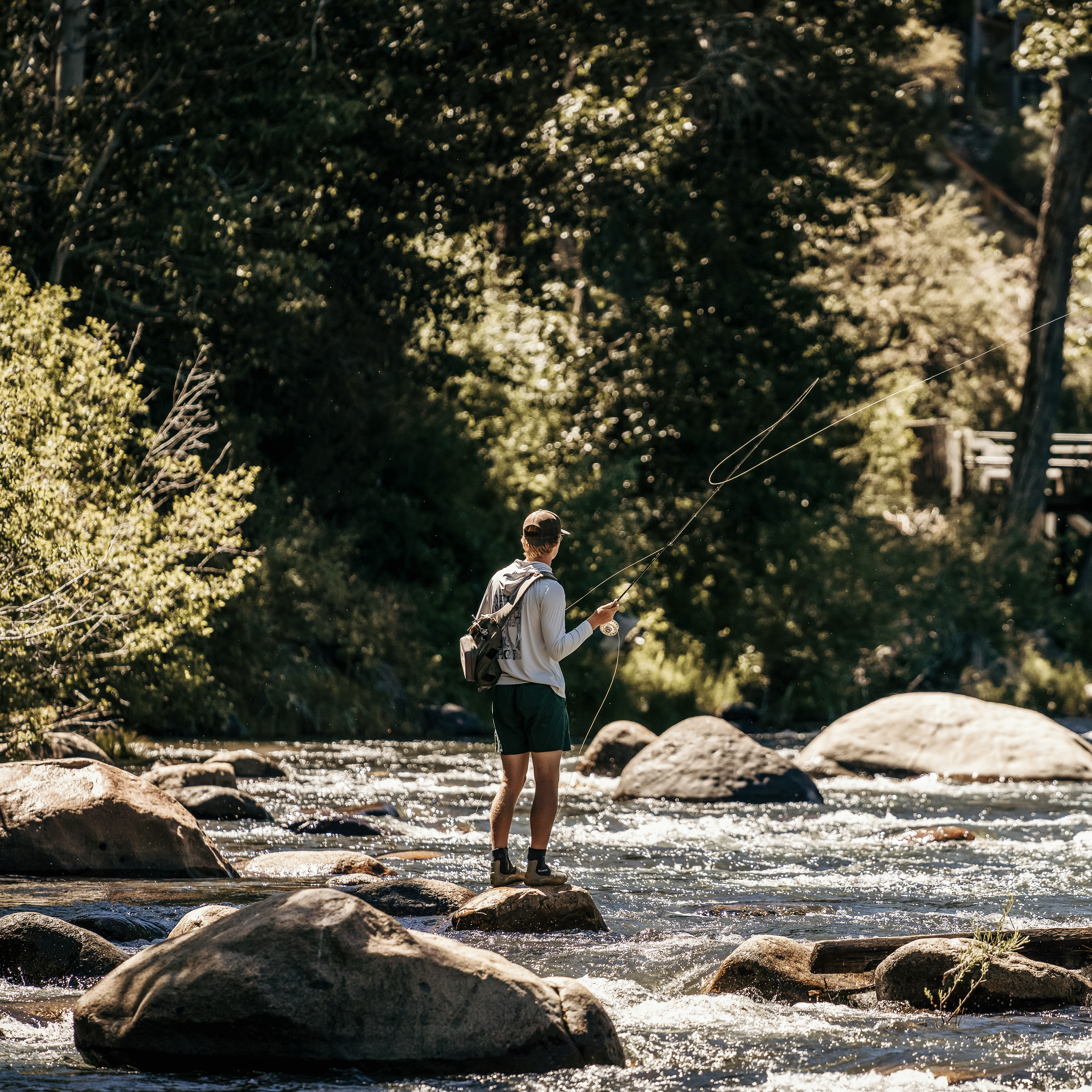 person fly fishing in river